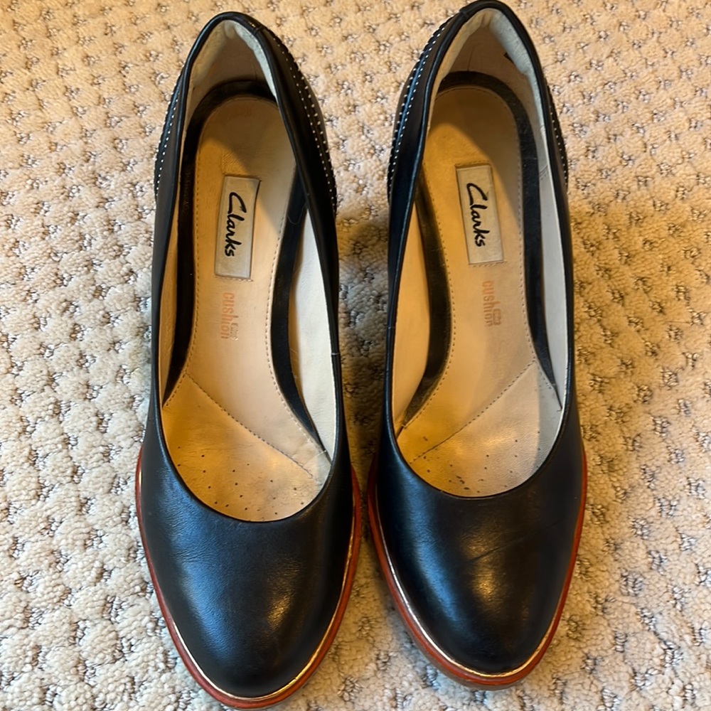 Clarks- Black size 7 1/2 gold and light orange accent around sole.